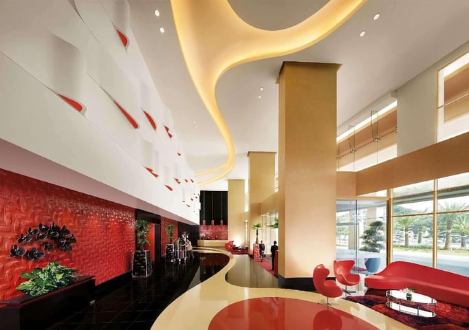 a red and white lobby with a large red table