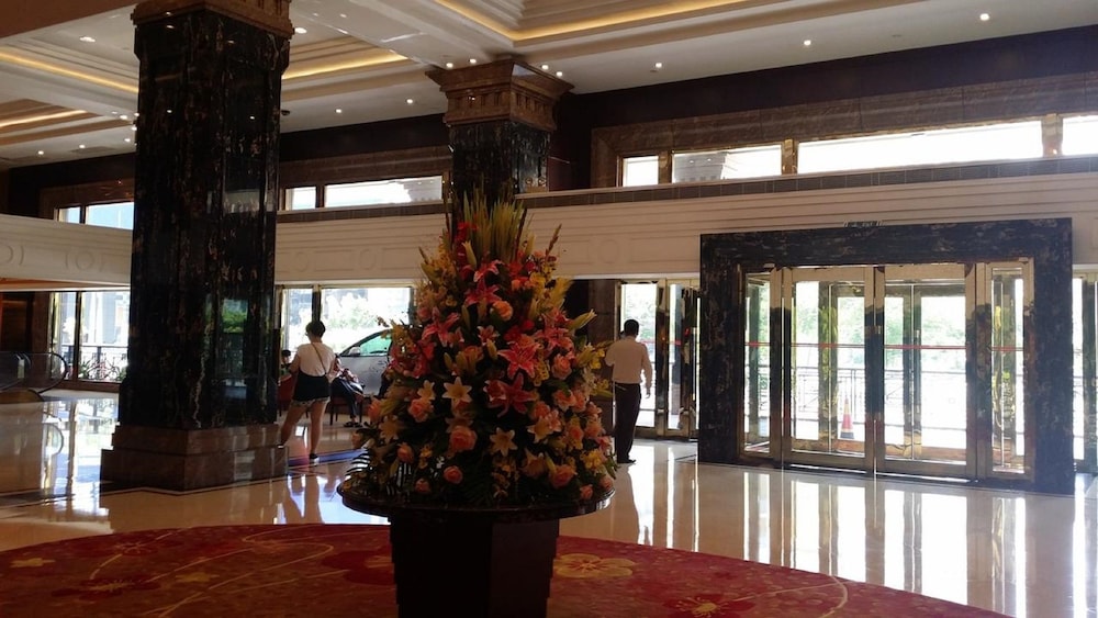 a large vase with flowers in it in a lobby