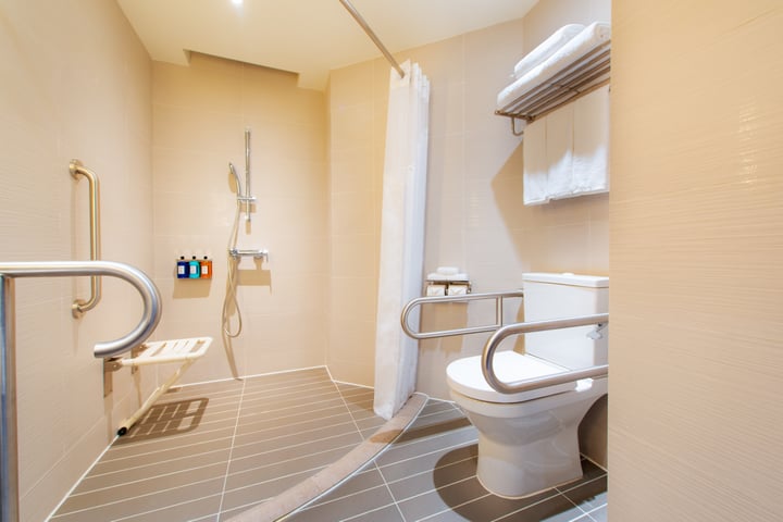 a bathroom with a toilet, shower, and sink
