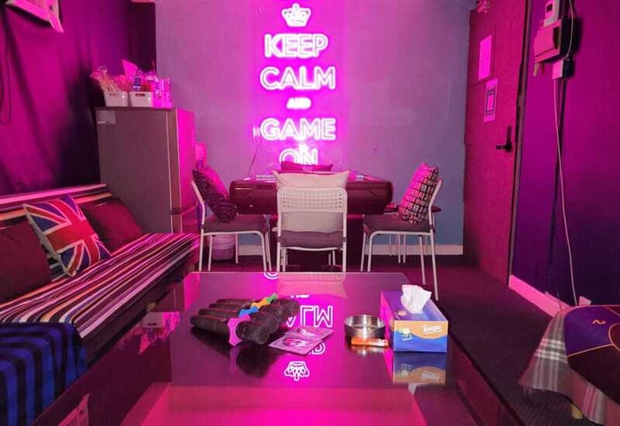 a room with purple walls and a purple neon sign