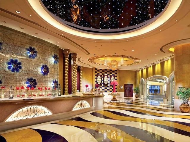 a large lobby with a large ceiling and a large mirror