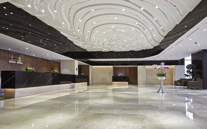 a large lobby with a marble floor and a large ceiling