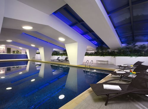 a swimming pool with a lounge chair and a pool
