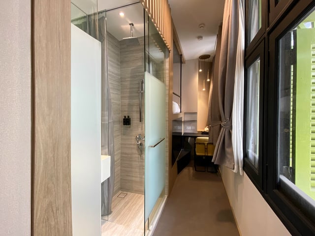 a bathroom with a glass shower and a sink
