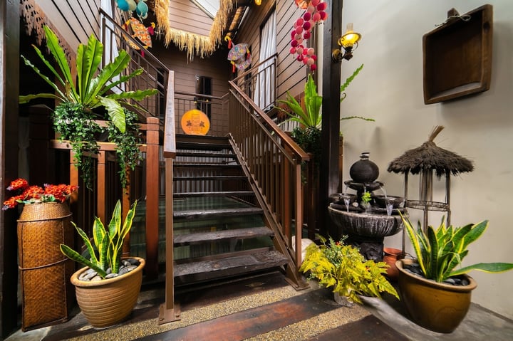 a staircase with plants and a bird on the wall