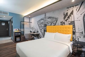 a bed in a room with a large wall mural