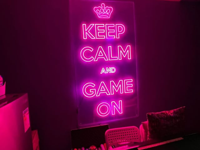 a neon sign that says keep calm and game on