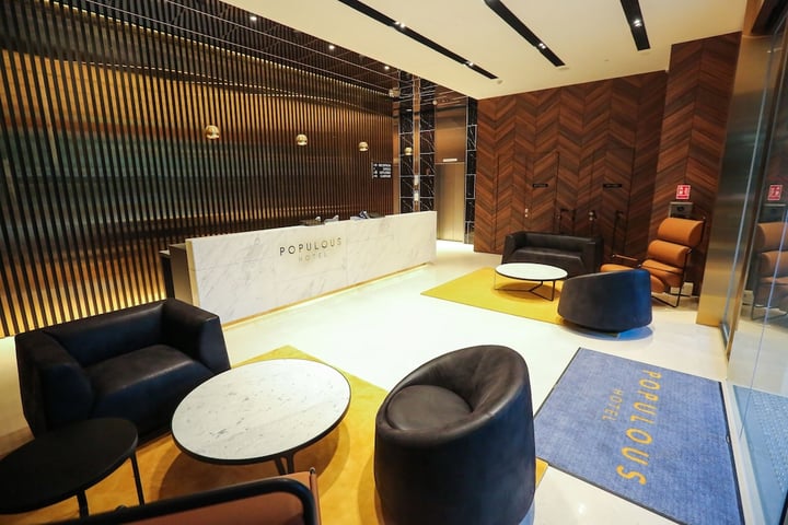 a lobby with a marble reception desk and chairs